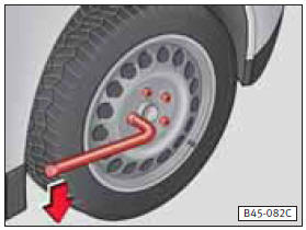 • Meter la llave hasta el tope sobre el tornillo de rueda (véase la figura) y