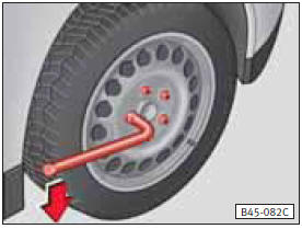• Meter la llave hasta el tope sobre el tornillo de rueda (véase la figura) y